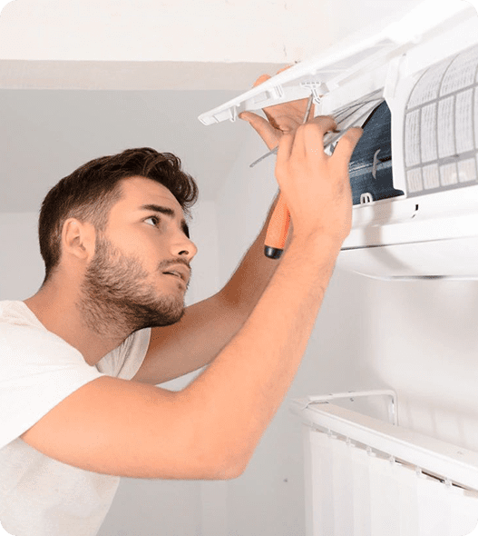 A man is fixing the air conditioner