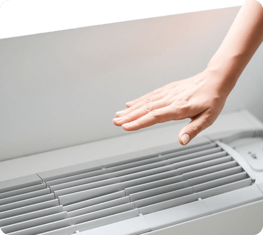 A hand is reaching out to touch the air vent.