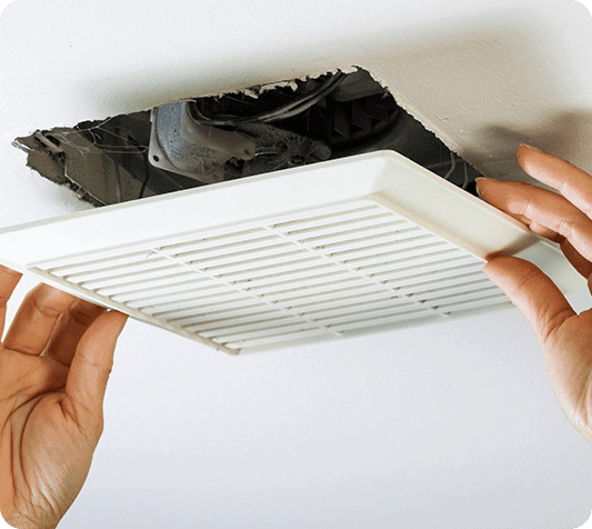 A person is holding the vent on the ceiling.