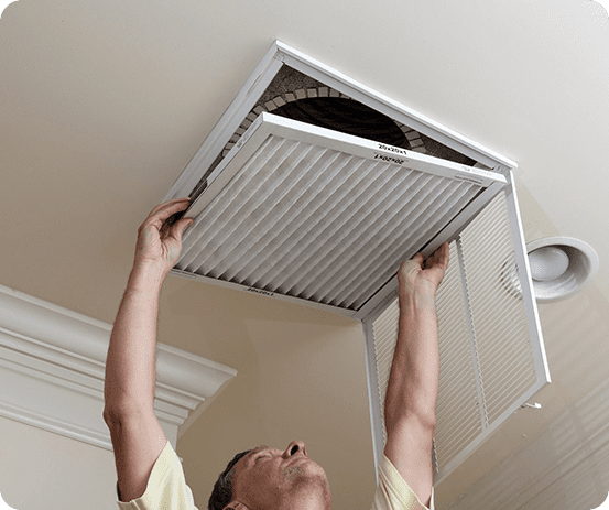 A man is holding on to the air filter.