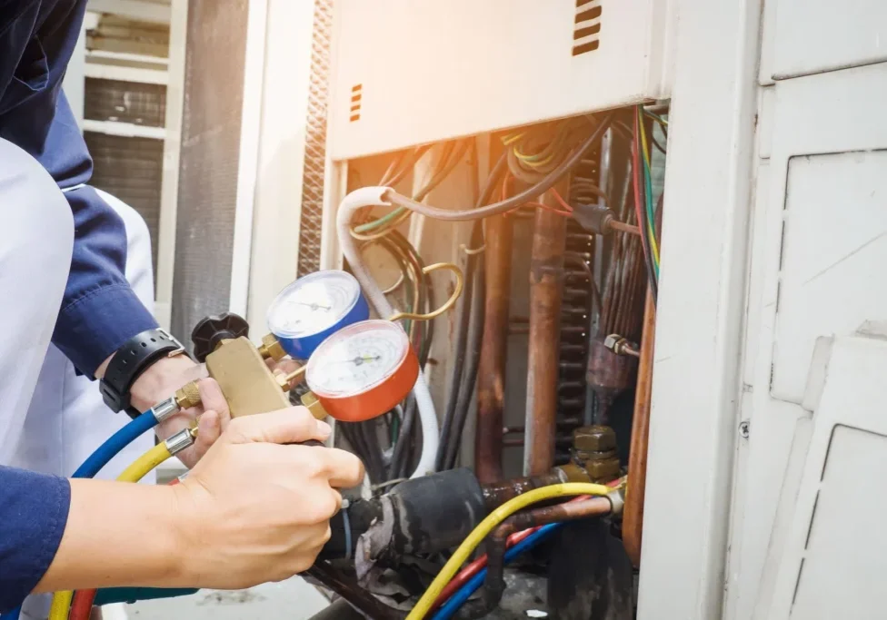 A person is working on an air conditioner.